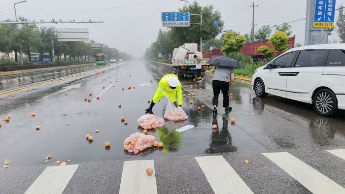 雨天車輛打滑貨物散落路面，大荔交警冒雨暖心相助。